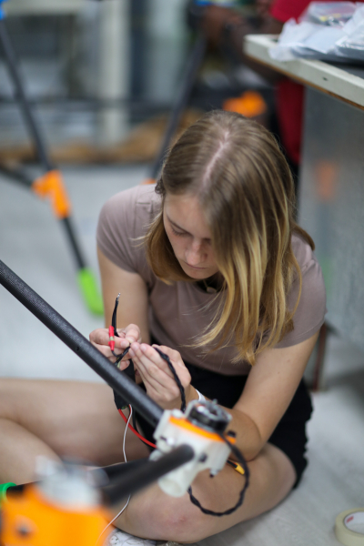 Duke mechanical engineering student Alison Korn assembles the mother drone in preparation for airworthiness testing.