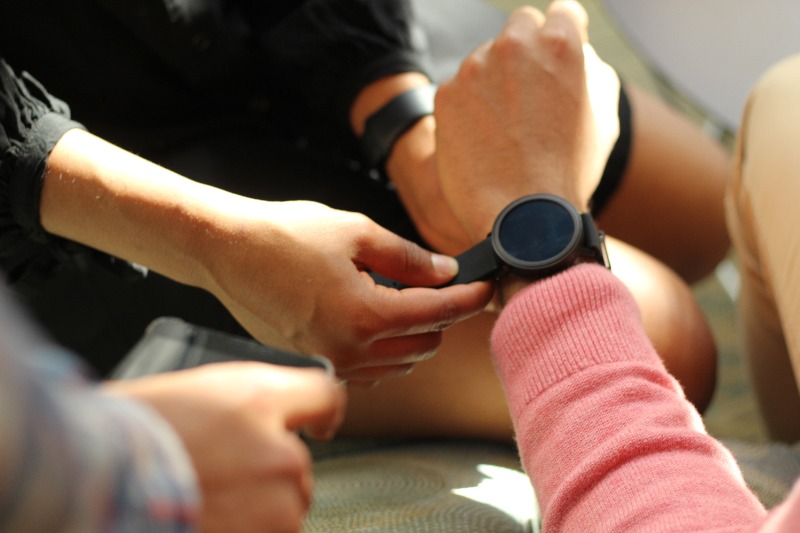 Fastening a fidget watch onto a wearer's wrist