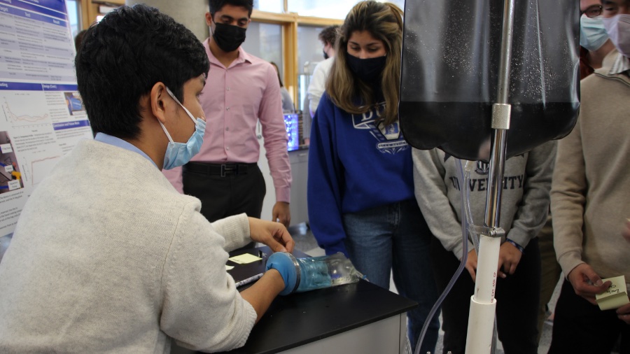 student models a prototype cryo-glove to bystanders