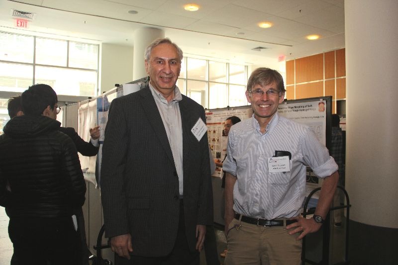 Michael Rubinstein and Stefan Zauscher peruse research posters at the 2019 Triangle Soft Matter Workshop