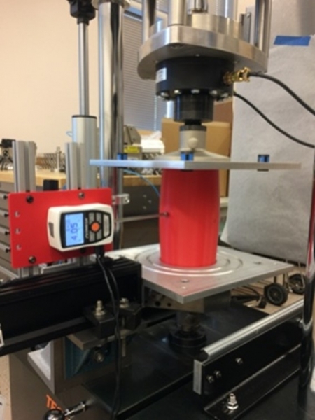 Probing the stability of a 3D-printed, compressed, cylindrical shell